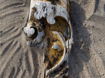 An intricately carved piece of ornamentation from the bowsprit, where you might expect to find a figurehead. The floral design of the carving can be seen on the 1884 painting of Nova Zembla.