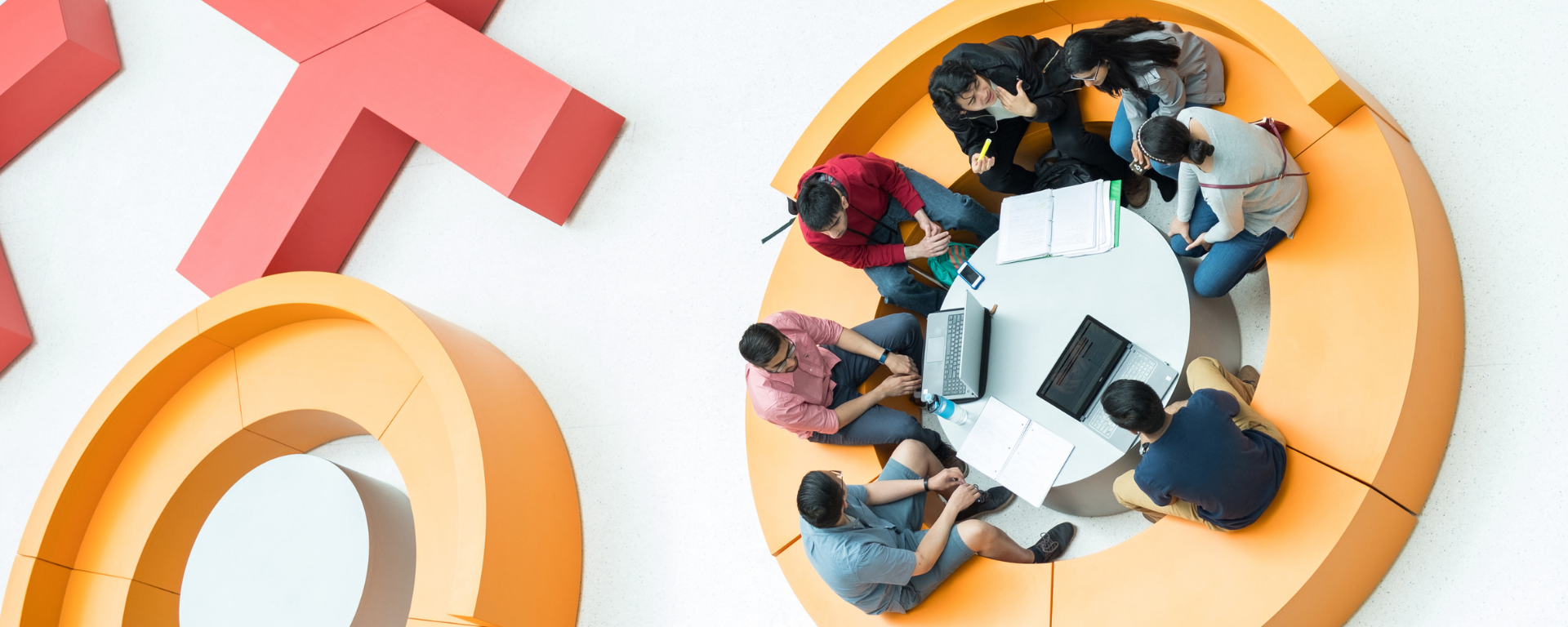 Aerial image of students sitting on chairs shaped like x's and o's