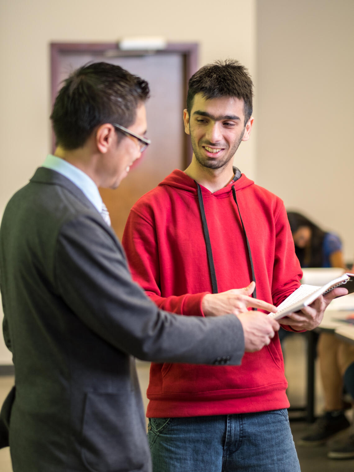 A student speaking with their teacher.