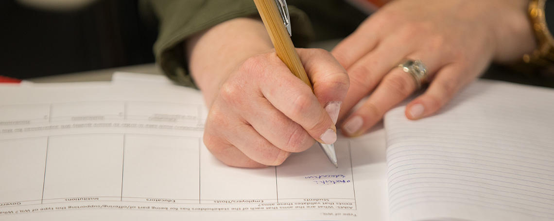 Person writing on paper