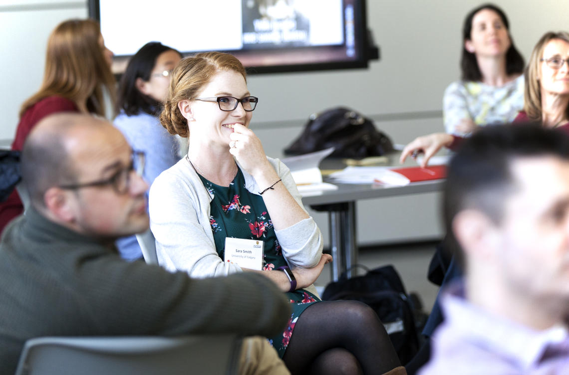 People sitting in a classroom participating in a workshop