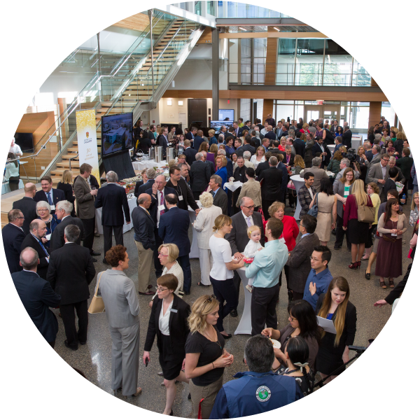 People gathered in atrium of the Taylor Institute building during an event