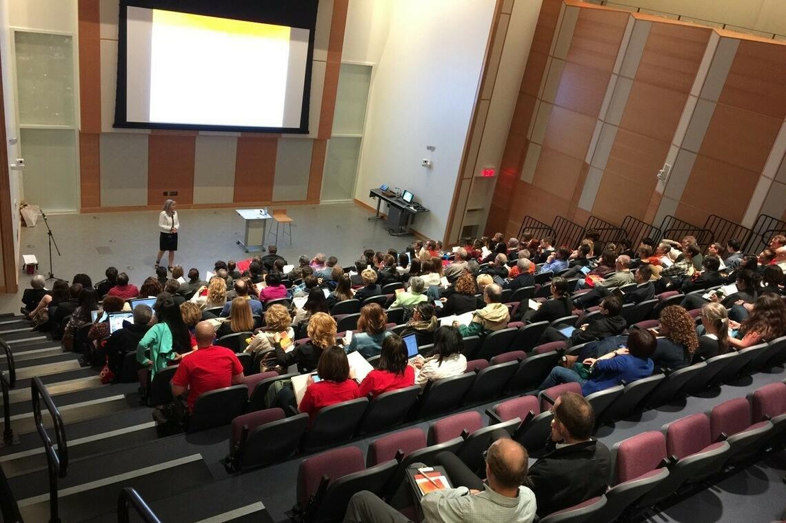 Taylor Institute forum shown with bleacher seating extended into the room