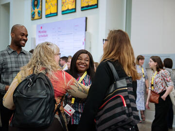 People smile in a busy room
