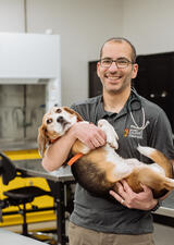 Serge Chalhoub holds a dog in a veterinary lab