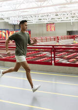 Nick Basilio runs along the racing track in the Jack Simpson Gymnasium