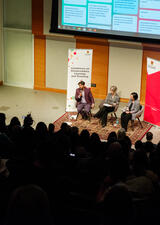 Attendees sit in bleachers at the annual conference