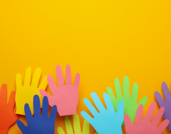 Felt, differently coloured hands are raised in front of an orange background